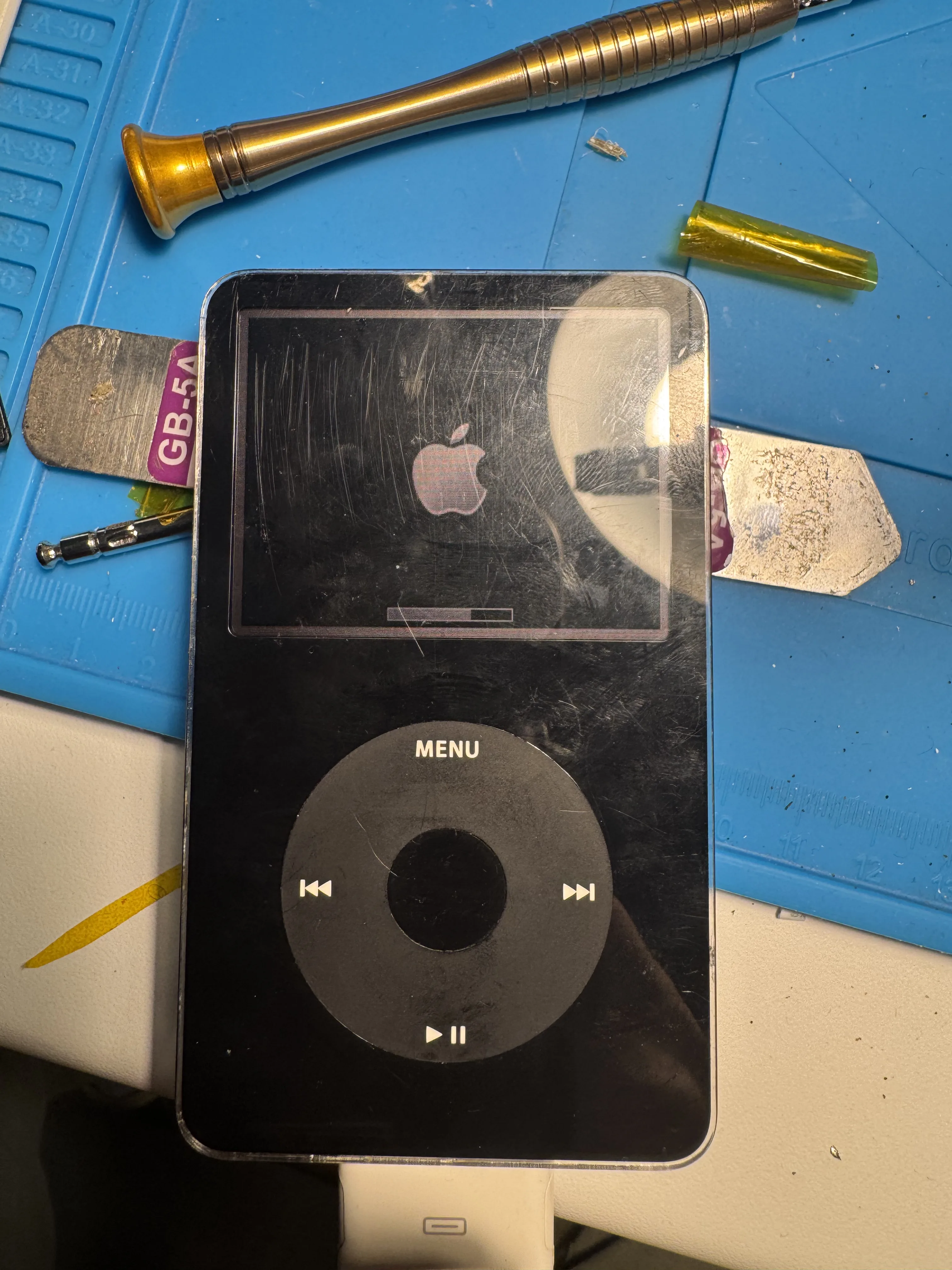 Scratched black iPod faceplate