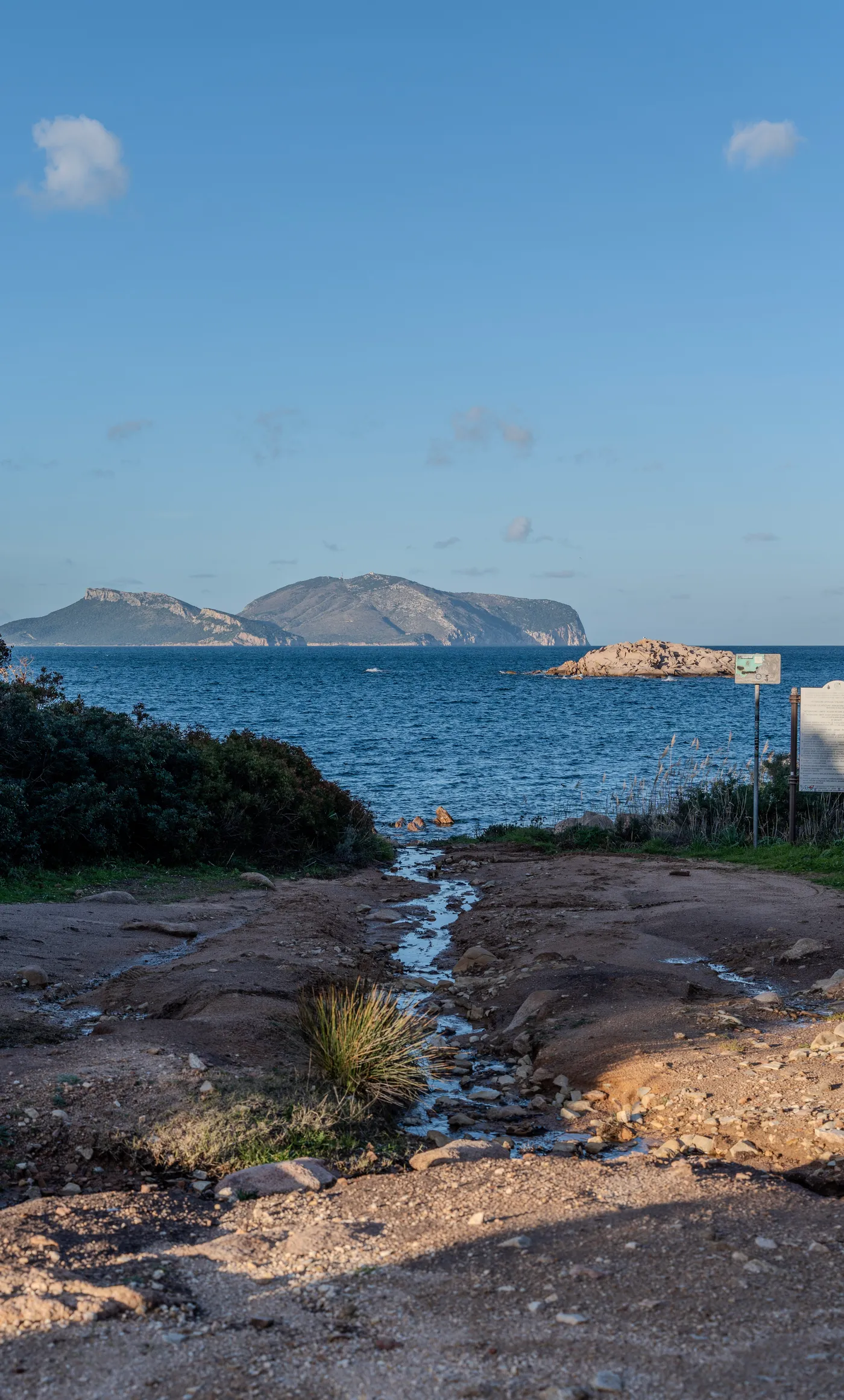 An island across the strait, a winter stream cutting down to the sea.