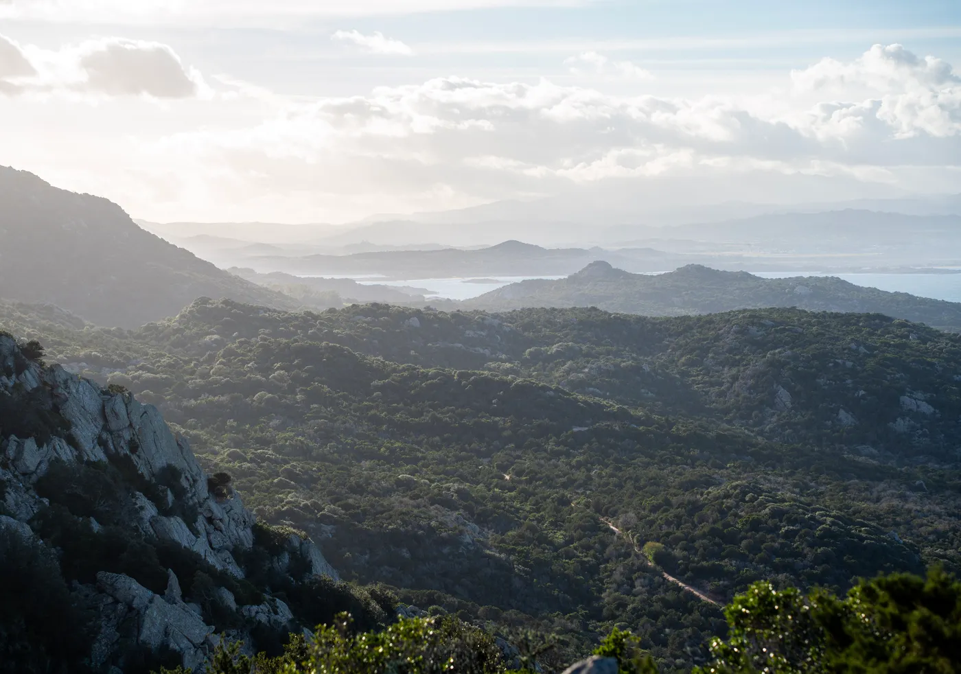 Granite ridges and maquis rolling down to the gulf.
