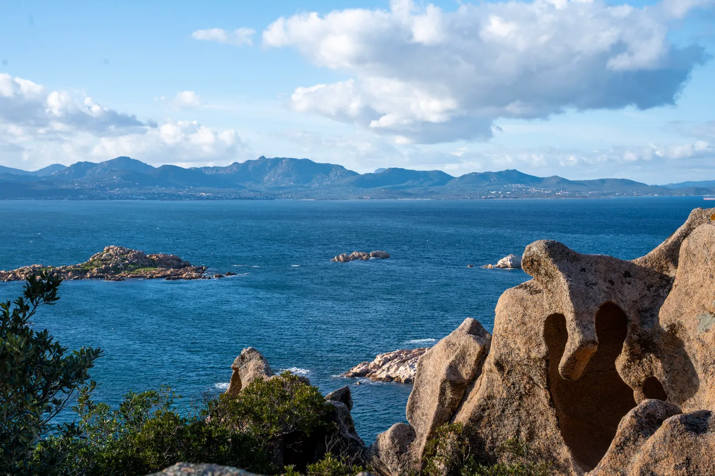 Wind-carved granite at the cape, the coast beyond.