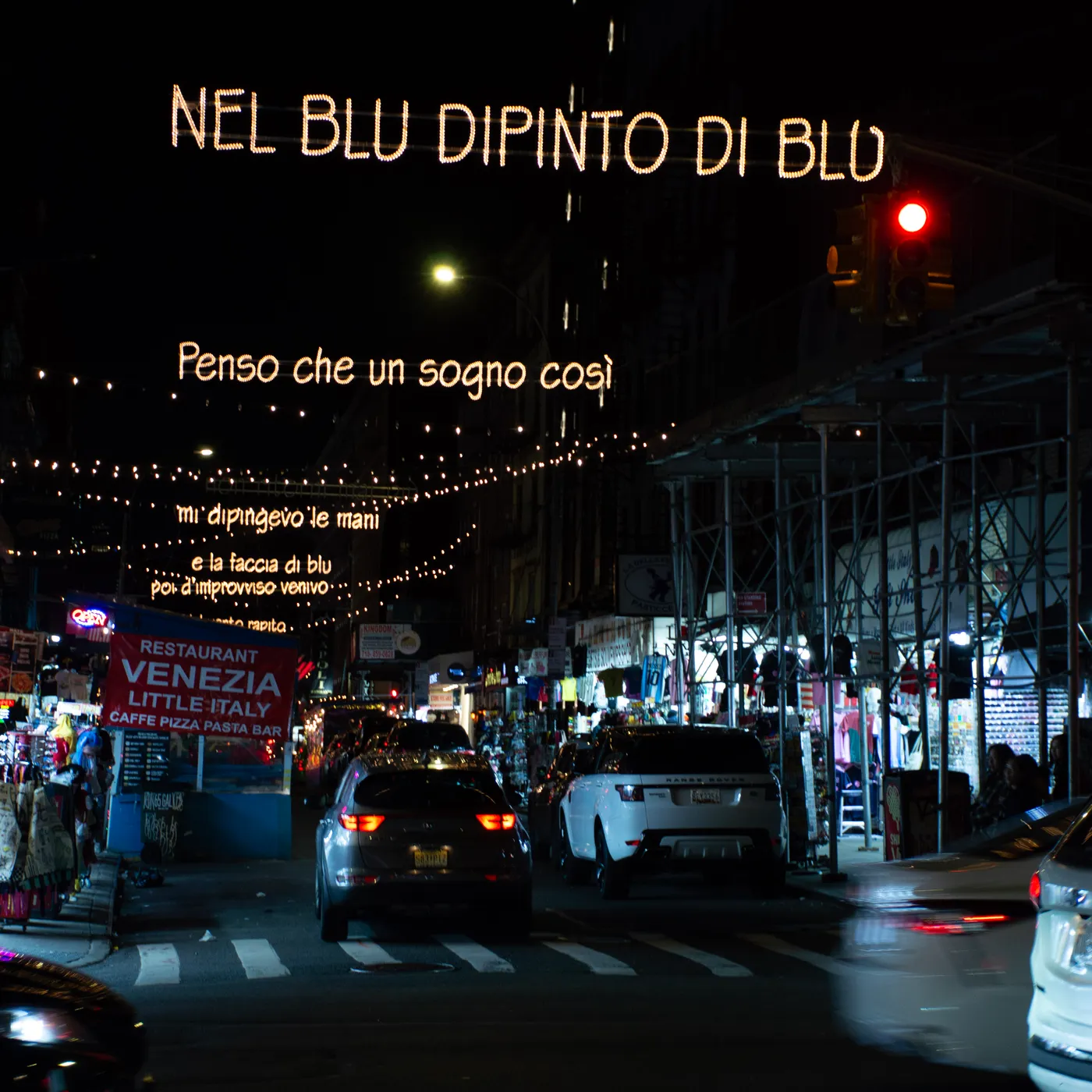 "Nel blu dipinto di blu" in lights across Mulberry Street, Little Italy.