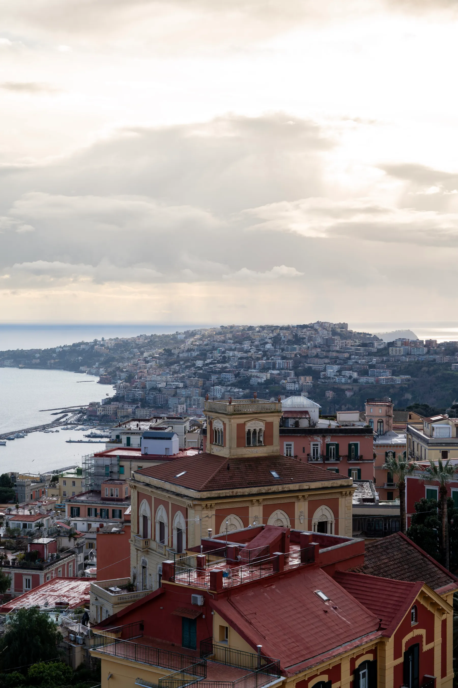 The hill of Posillipo running out to sea, the harbour of Mergellina below.