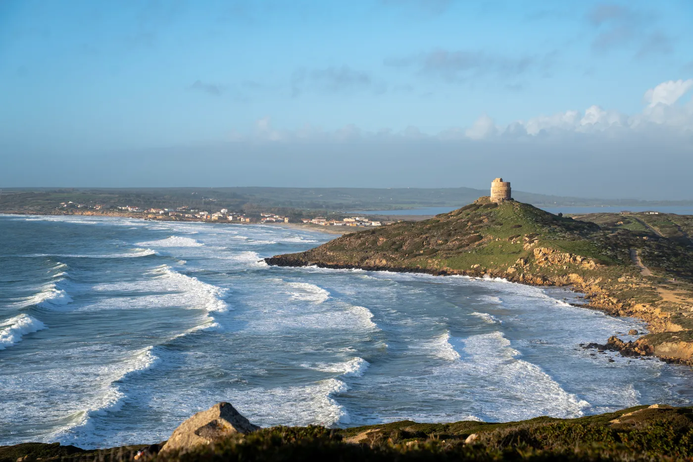 Winter swell rolling into San Giovanni di Sinis, the village behind the tower.