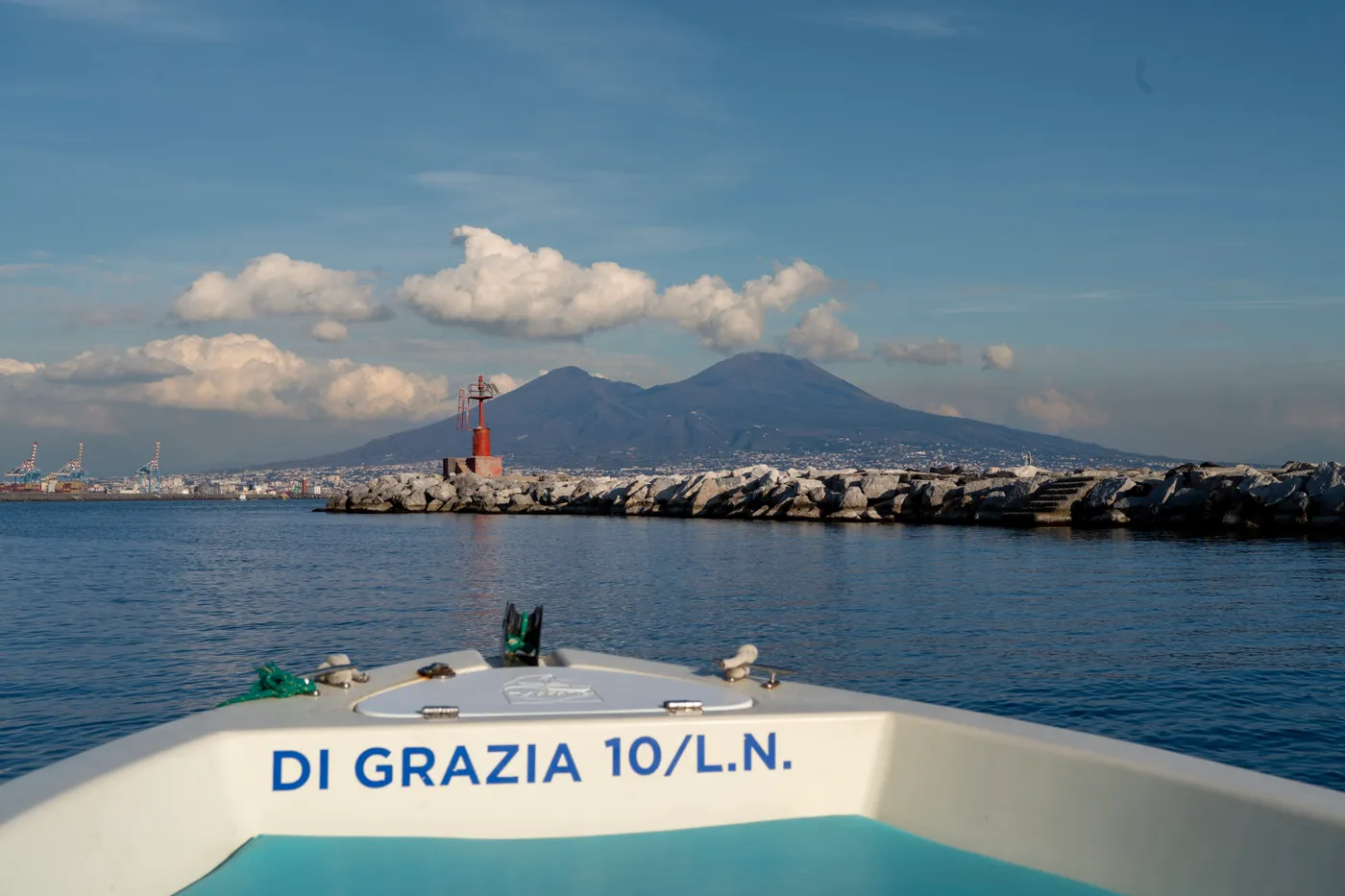 Leaving the harbour on a boat, Vesuvius across the gulf.