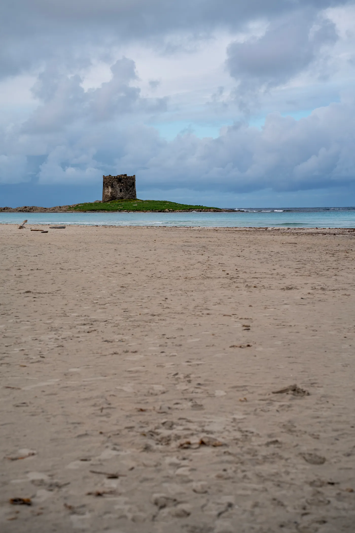 The Pelosa tower on its islet, Stintino, under a heavy sky.